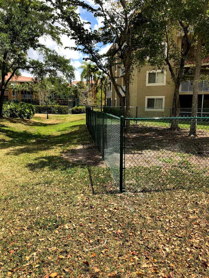 Chain Link Green Vinyl Fence — Sunrise, FL — First Class Fence & Rail, Inc.