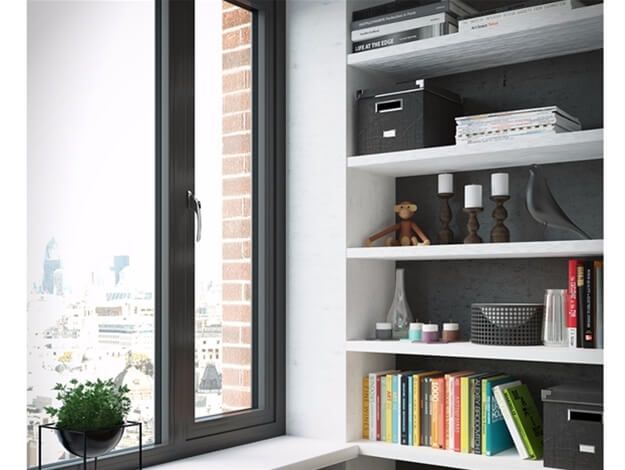 A room with a window and shelves filled with books and candles.