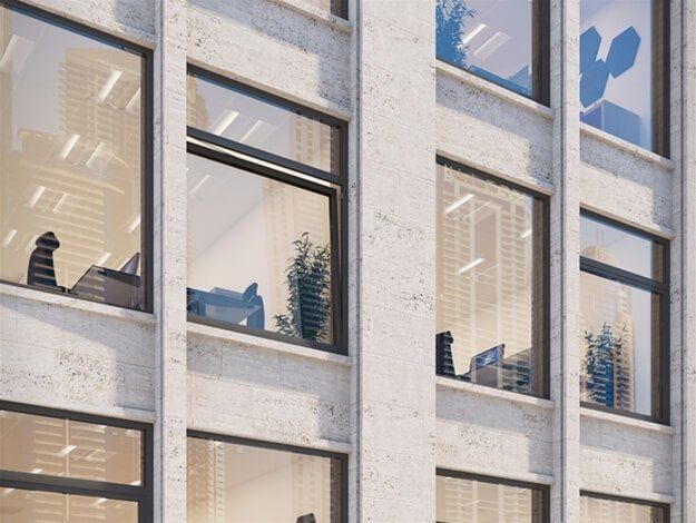 A building with a lot of windows and plants on the windowsill