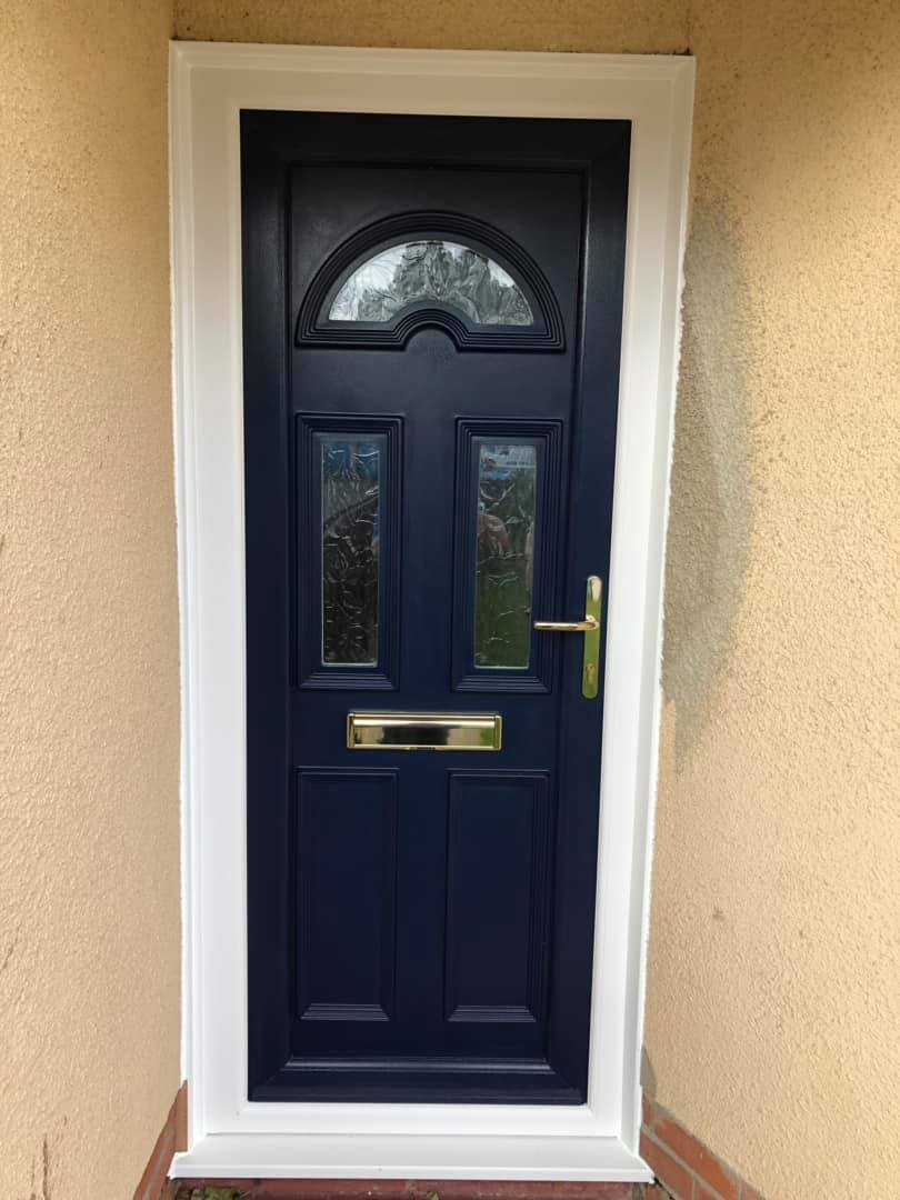 A blue door with a white trim is on a beige wall.
