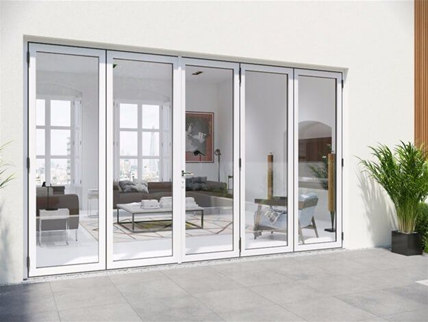 A living room with a lot of windows and a couch.