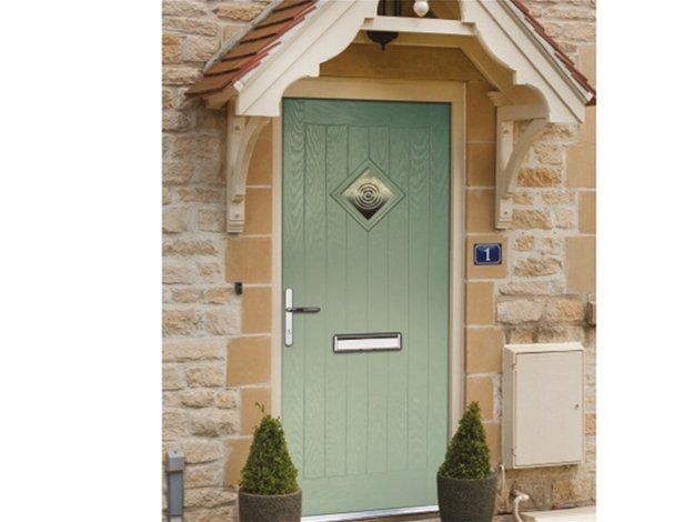 A green door with a canopy on top of it