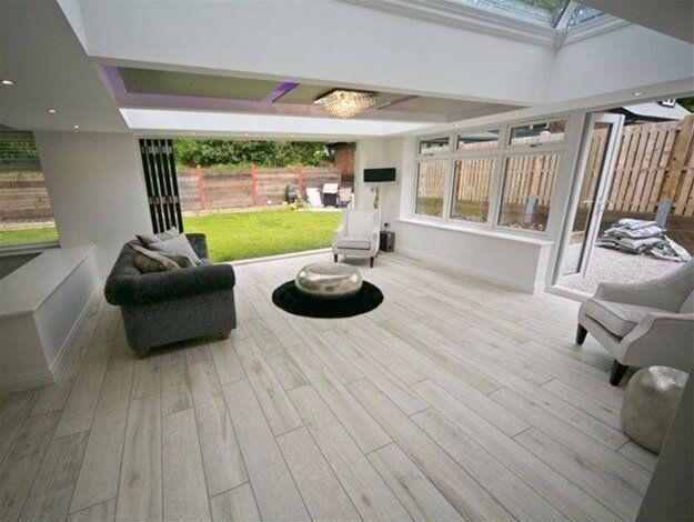 A living room with a couch and chairs and a table