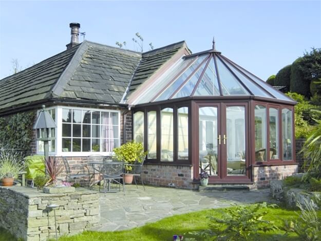 A house with a glass conservatory attached to it