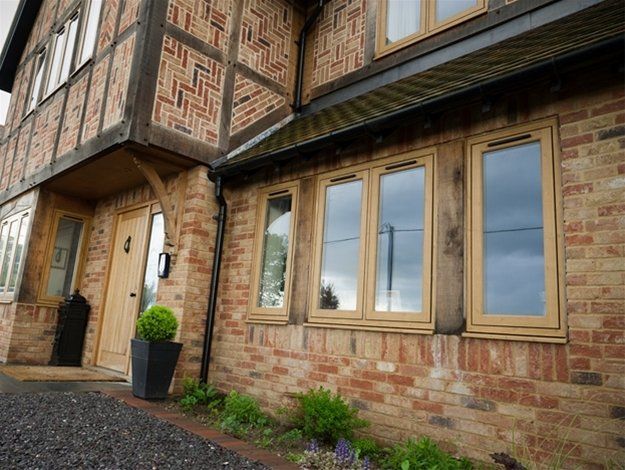 A large brick building with a wooden door and windows.