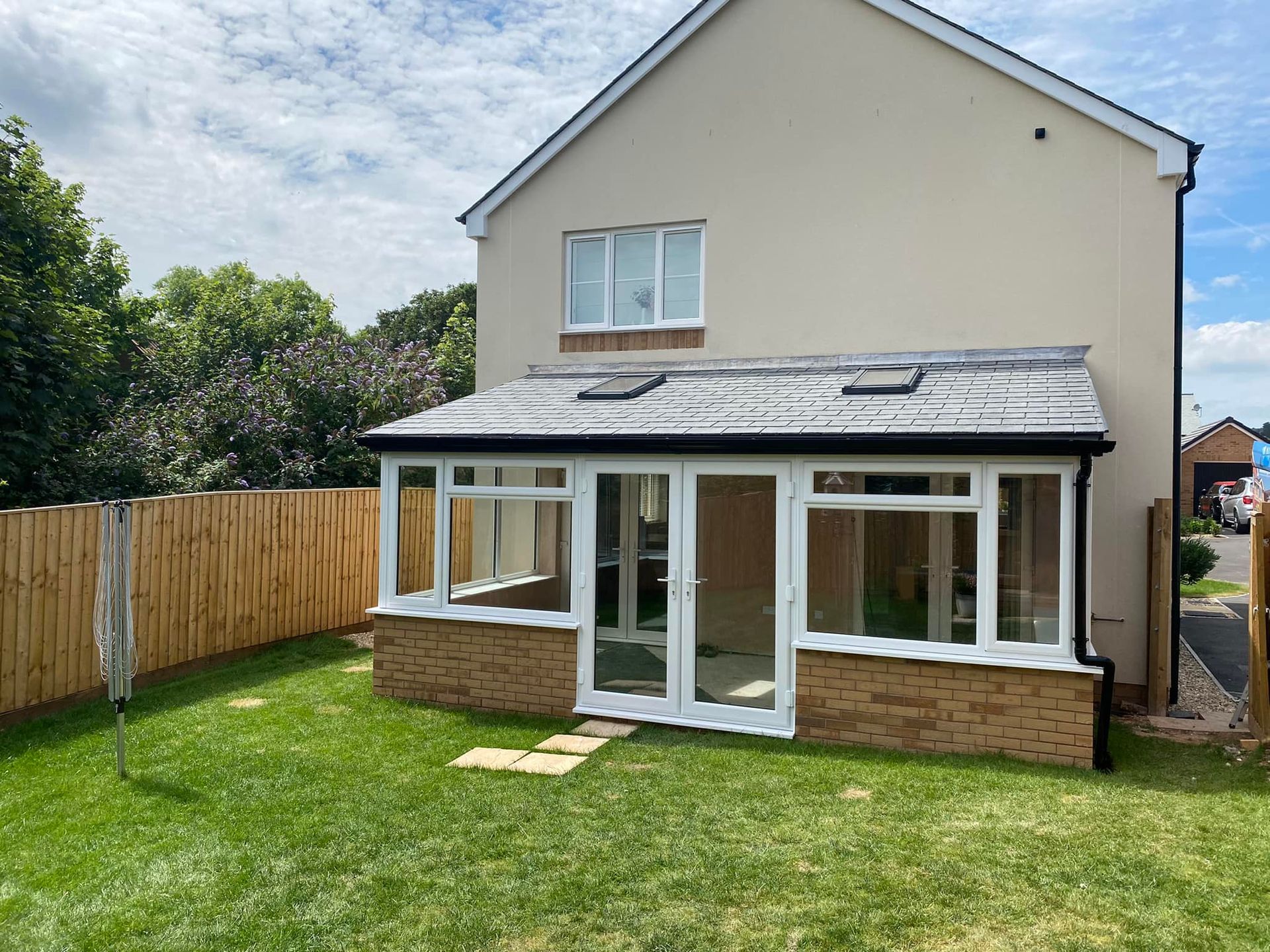 A house with a large lawn in front of it.