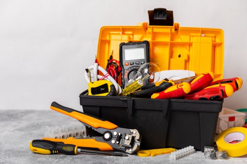 A toolbox filled with a variety of tools on a table.