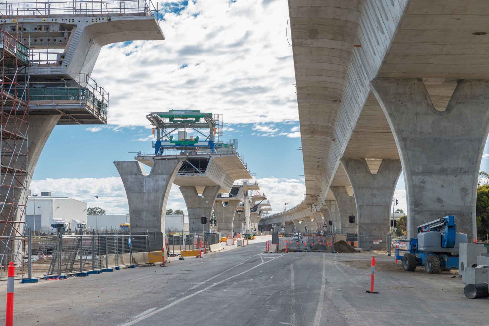 A concrete bridge is being built over a road.