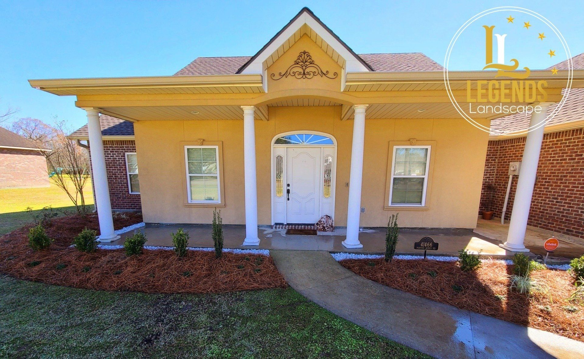 A yellow house with white columns and a sign that says legends