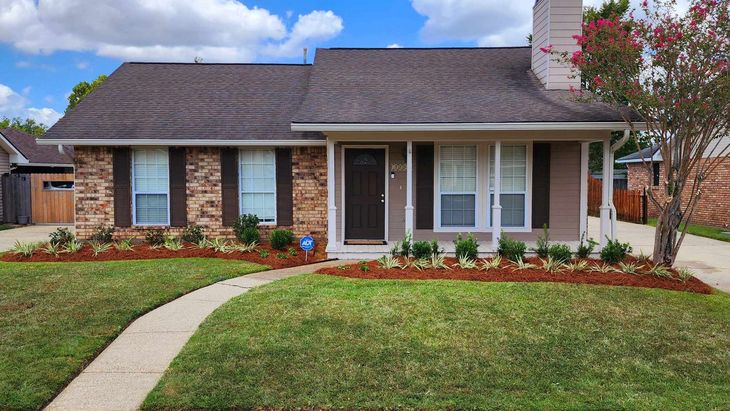 A brick house with a walkway leading to it