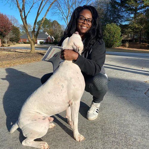 Woman Hugging a Dog — Loganville, GA — Paws & Parks