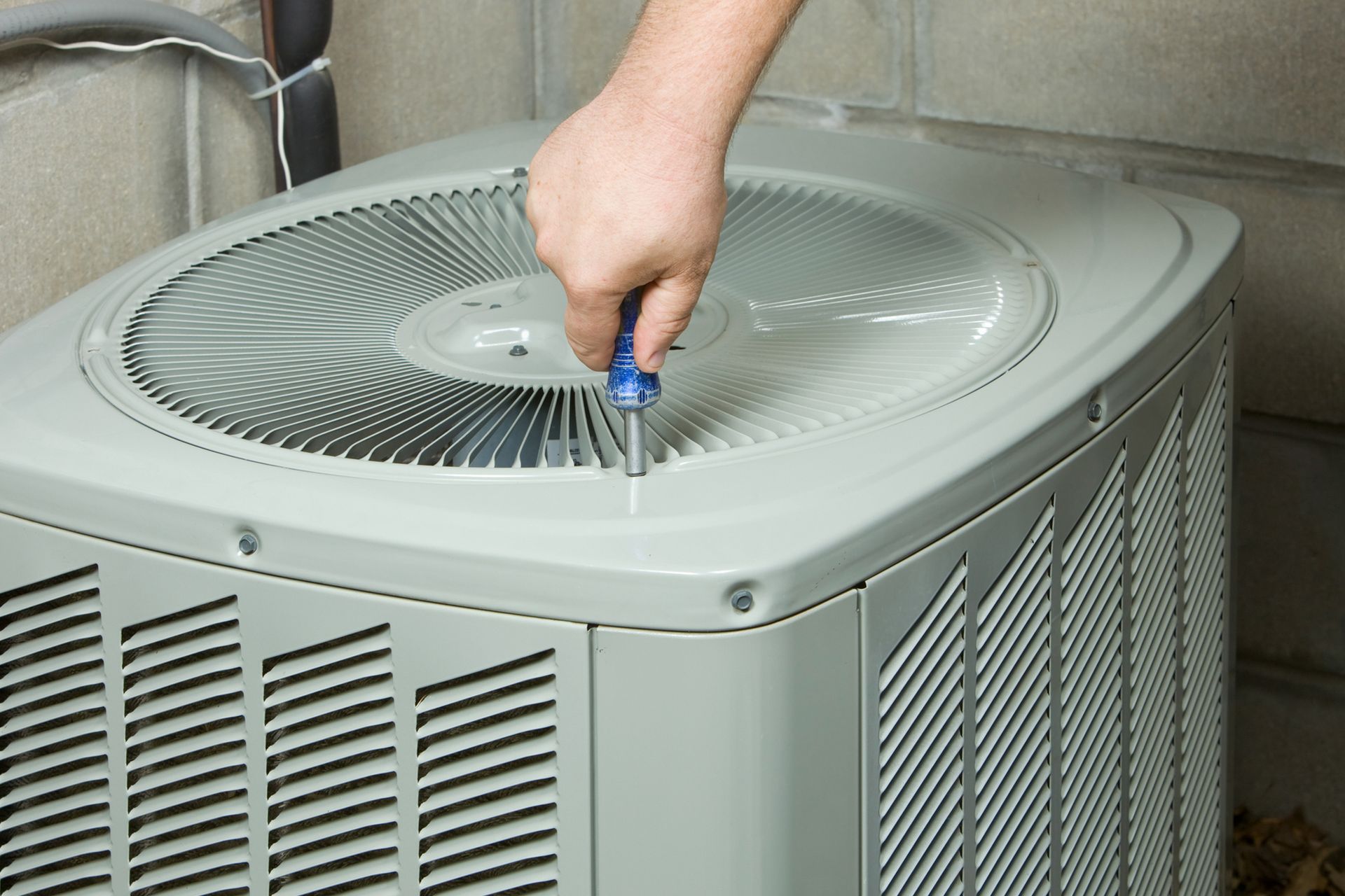 Installing Air Conditioner Fan Cover — Seymour, IN — Craig’s Heating and Air