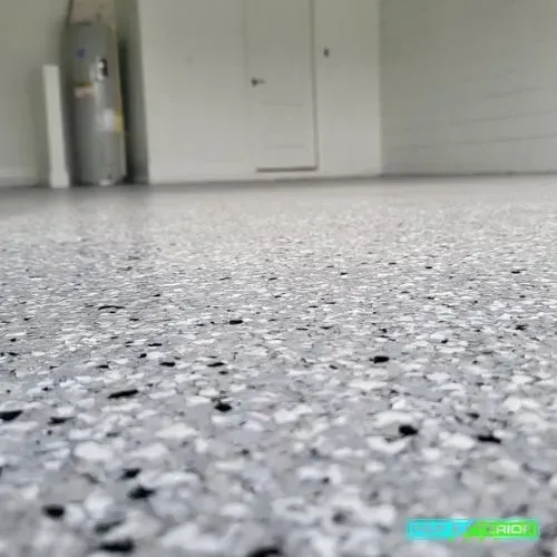 A close up of a gray and black floor in a garage.