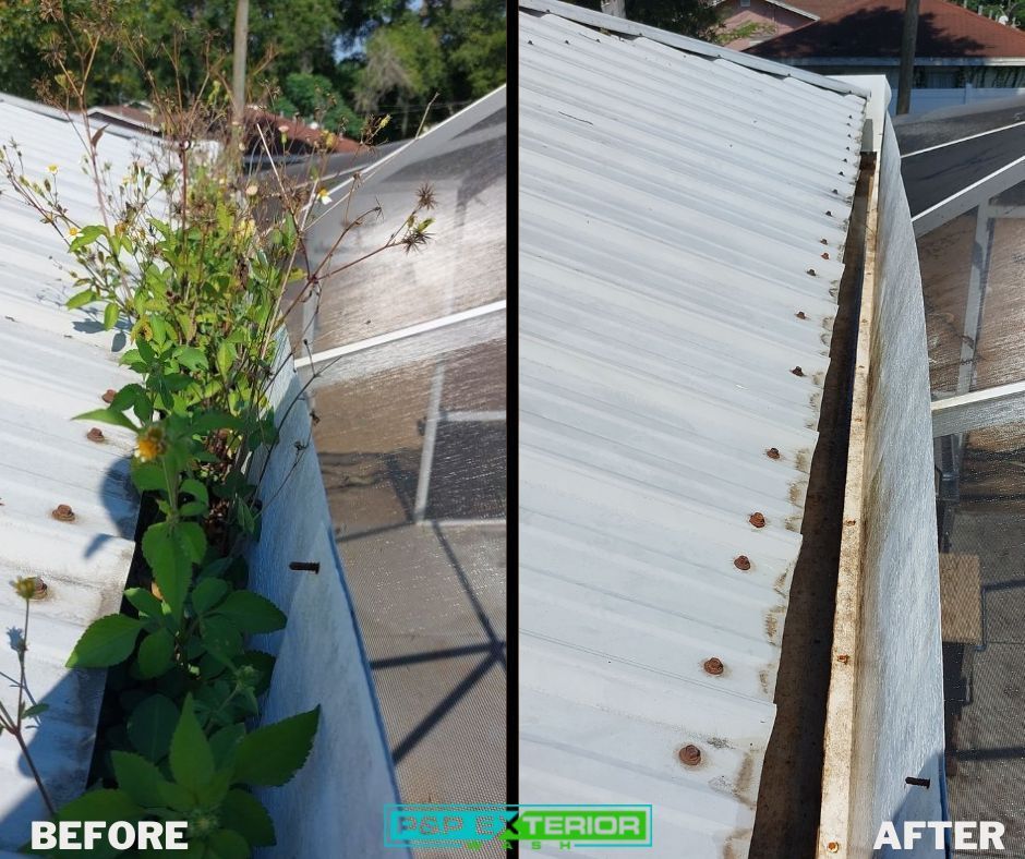 A person is cleaning a gutter on a roof.