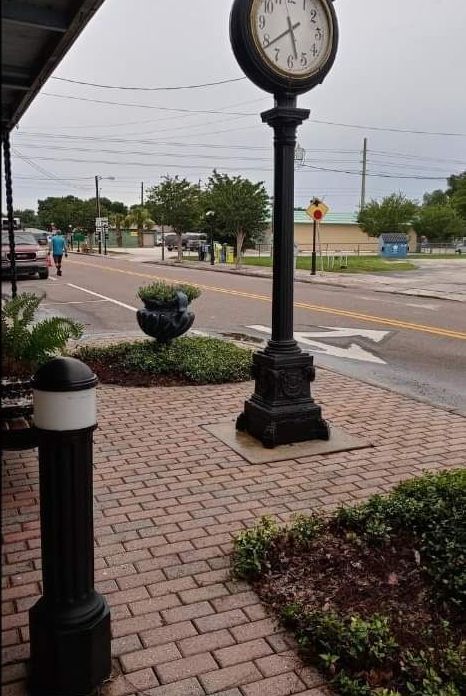 A clock on a pole shows the time as 4:20