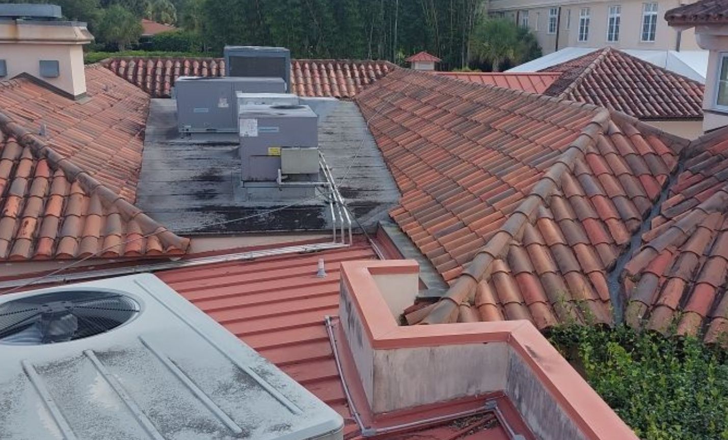 A roof with a lot of tiles and a chimney on it