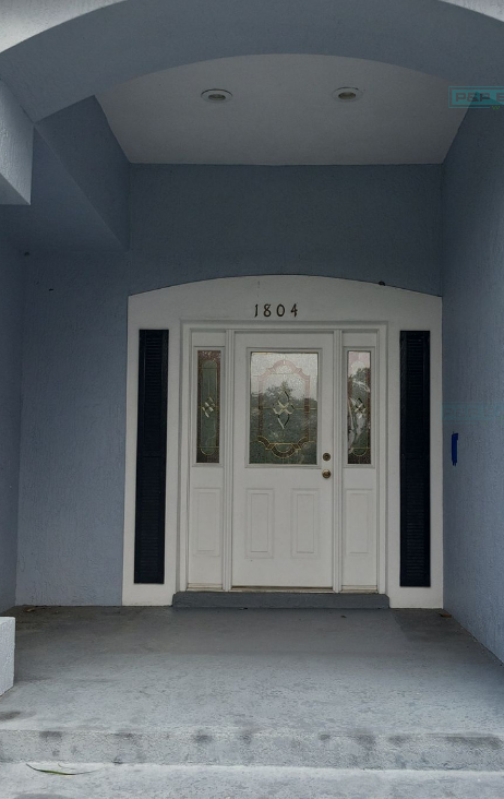 A white door with the number 1604 on it