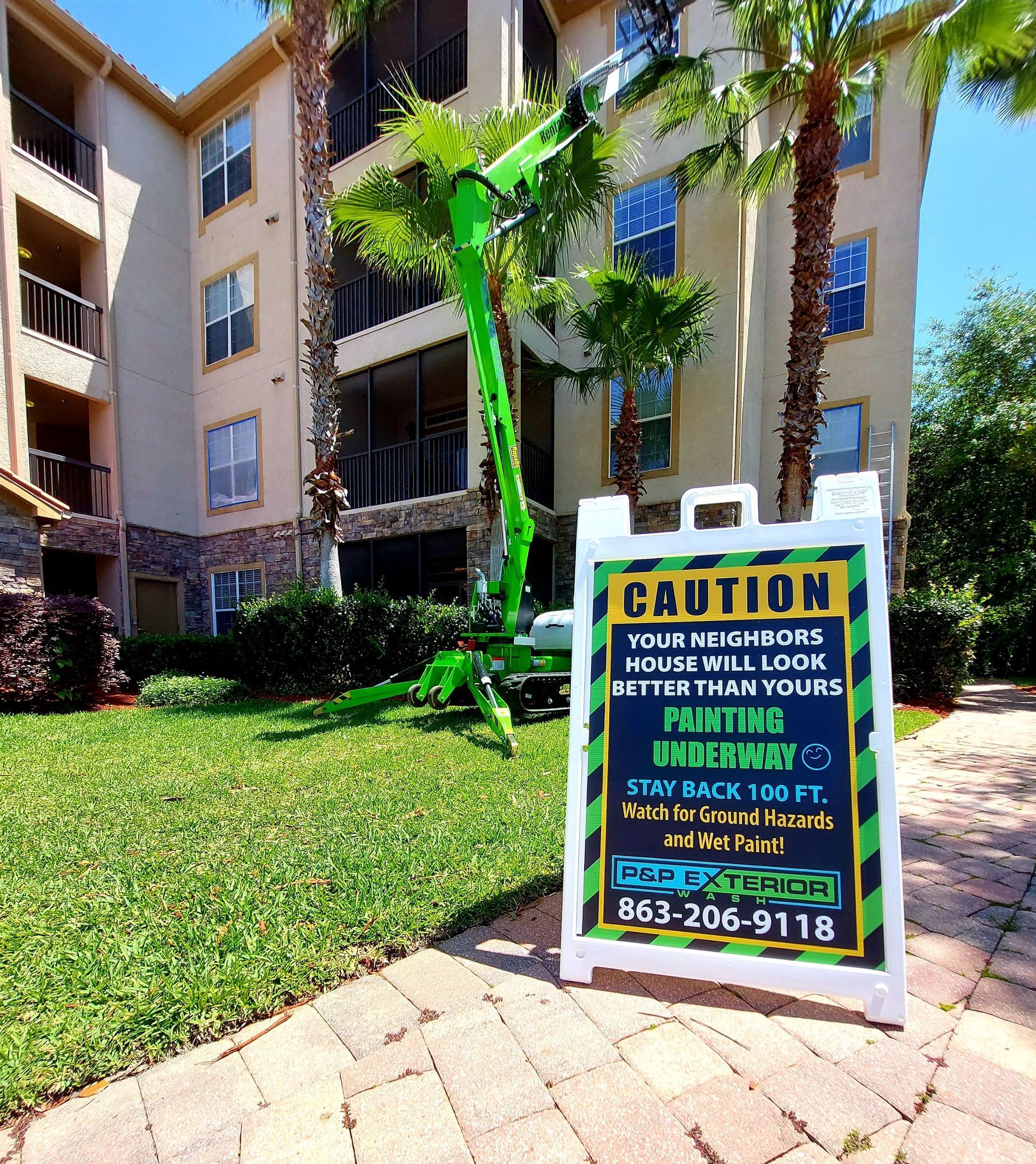 A white house with a black staircase leading up to the second floor
