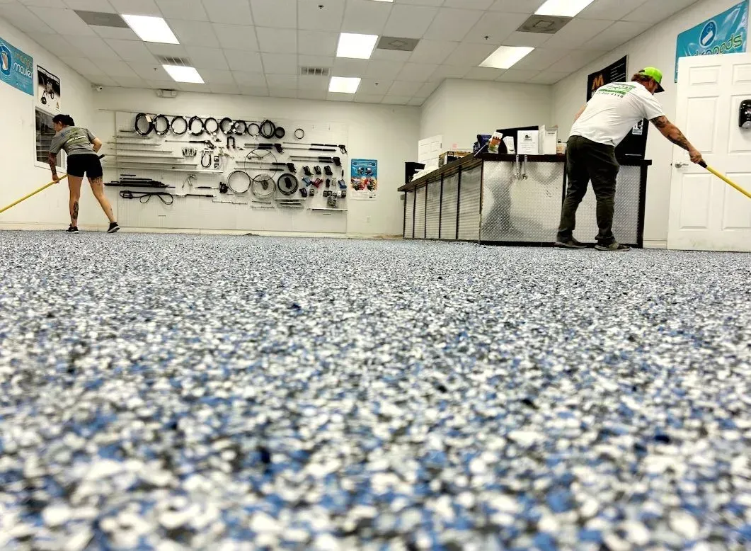 A man and a woman are standing on a carpeted floor in a room.