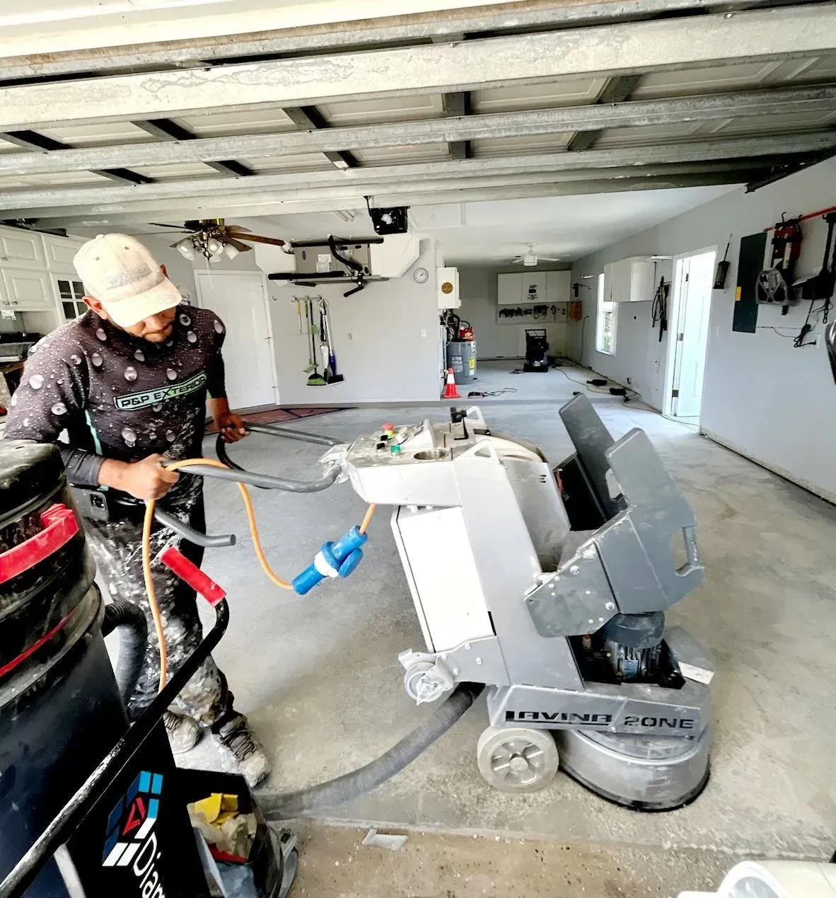 A man is working on a machine in a garage.