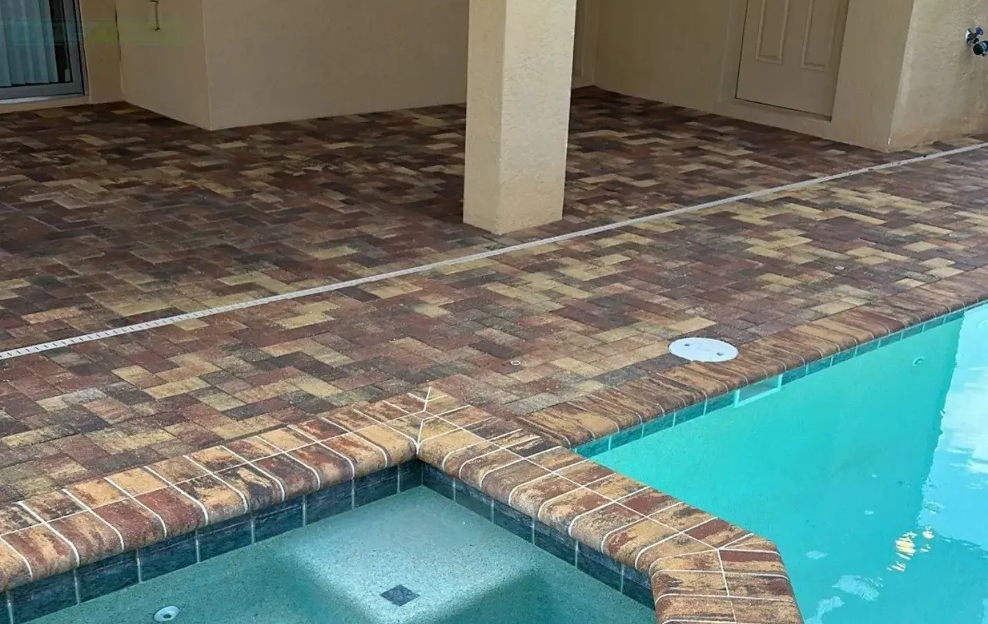 A swimming pool with a hot tub in the middle of it.