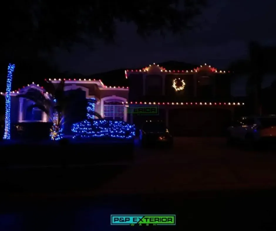 A house decorated with christmas lights and a sign that says p & p exterior