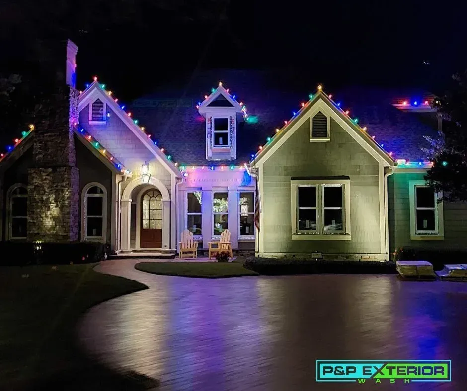 A house with christmas lights on the roof and a sign that says p & p exterior