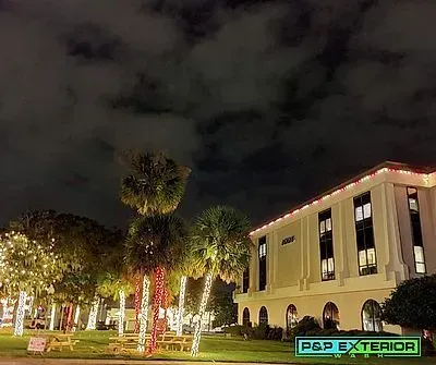 A large building with a lot of lights on it is lit up at night.