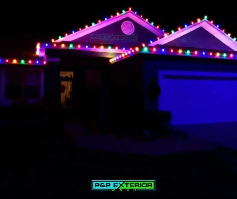 A house with christmas lights on it is lit up at night