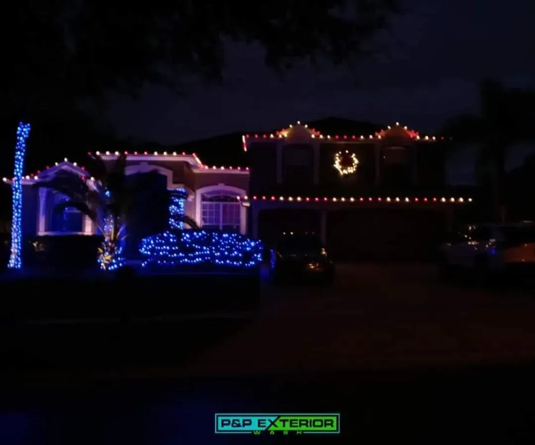 A house is decorated with christmas lights and a wreath