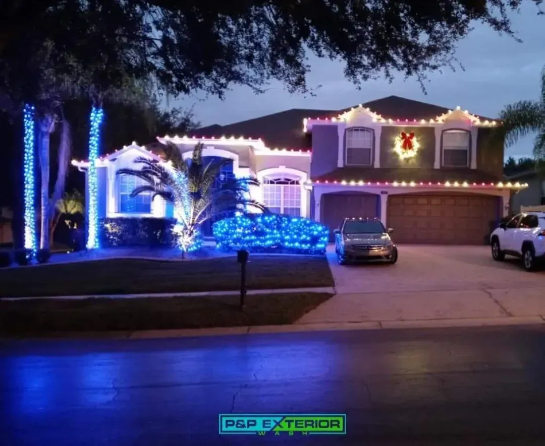A house is decorated with blue and white christmas lights