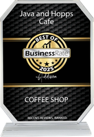 A plaque for java and hopps cafe is sitting on a table.