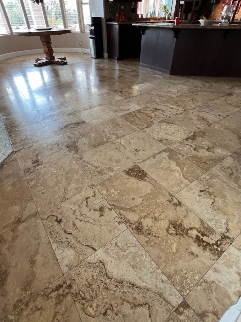 Beige travertine tile floor in a well-lit interior space.