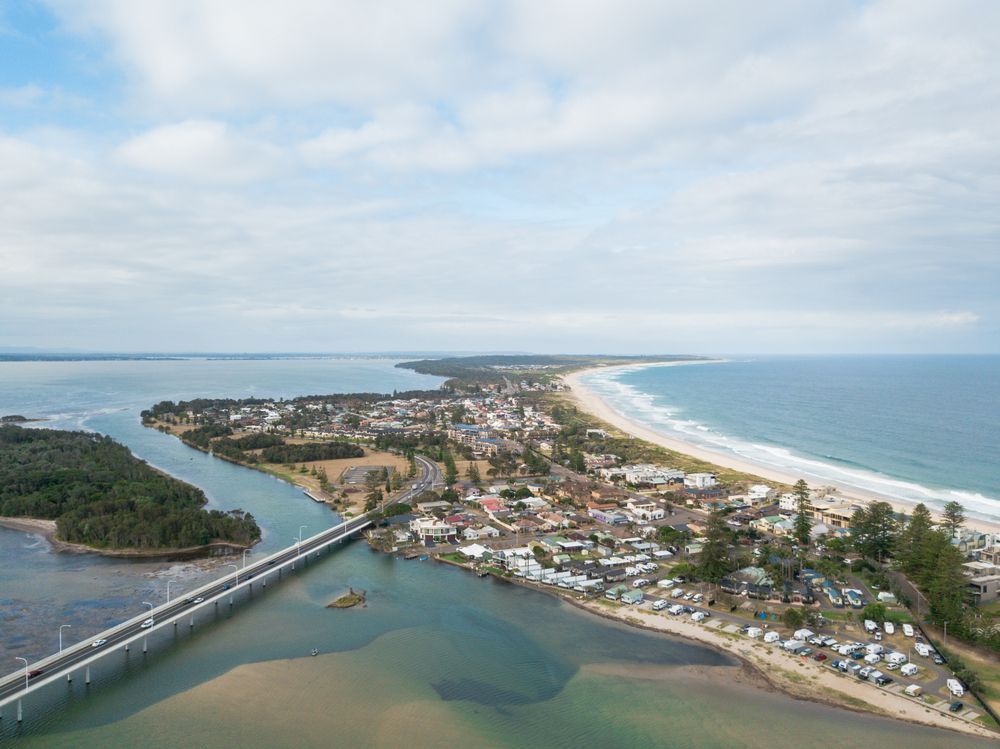 An Aerial View of a Bridge Over a River Leading to a Beach — Catrina's Custom Curtains & Blinds in The Entrance, NSW