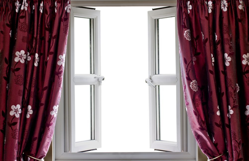 A White Window With Red Curtains and a White Background — Catrina's Custom Curtains & Blinds in Morisset, NSW