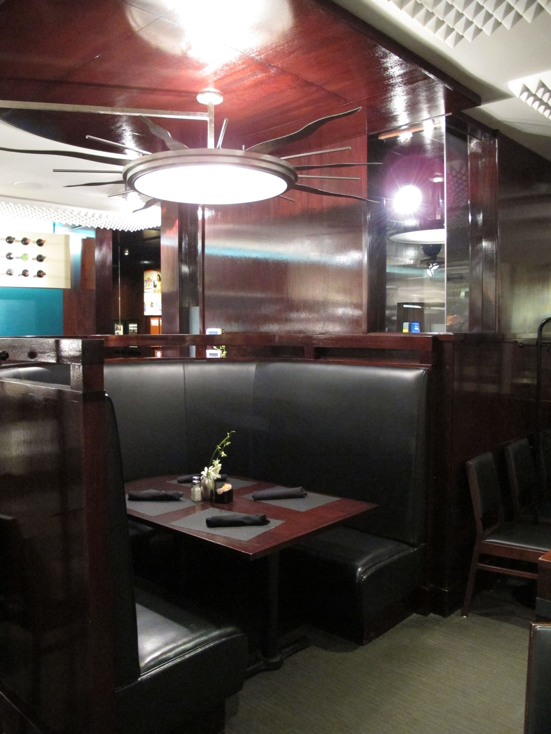 A booth in a restaurant with a table and chairs