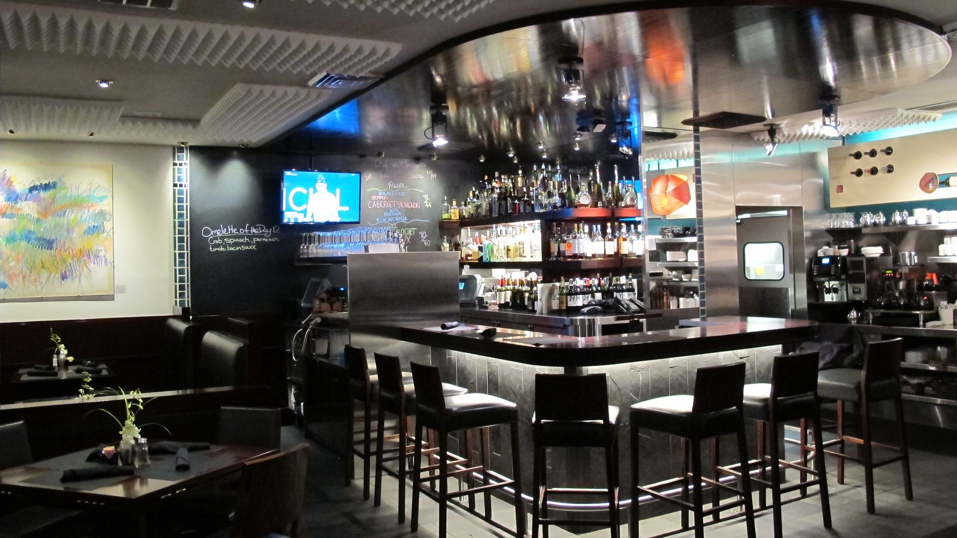 A restaurant with tables and chairs and a bar