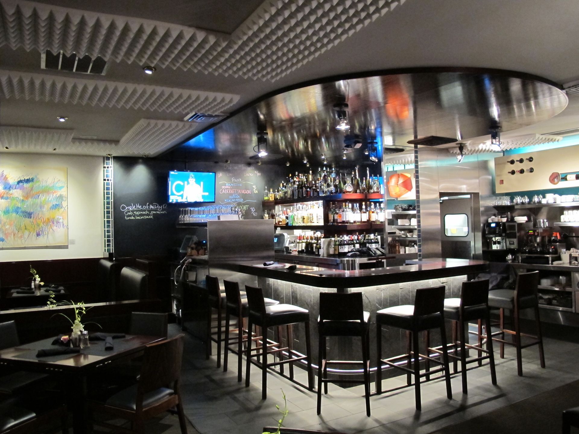 A restaurant with tables and chairs and a bar