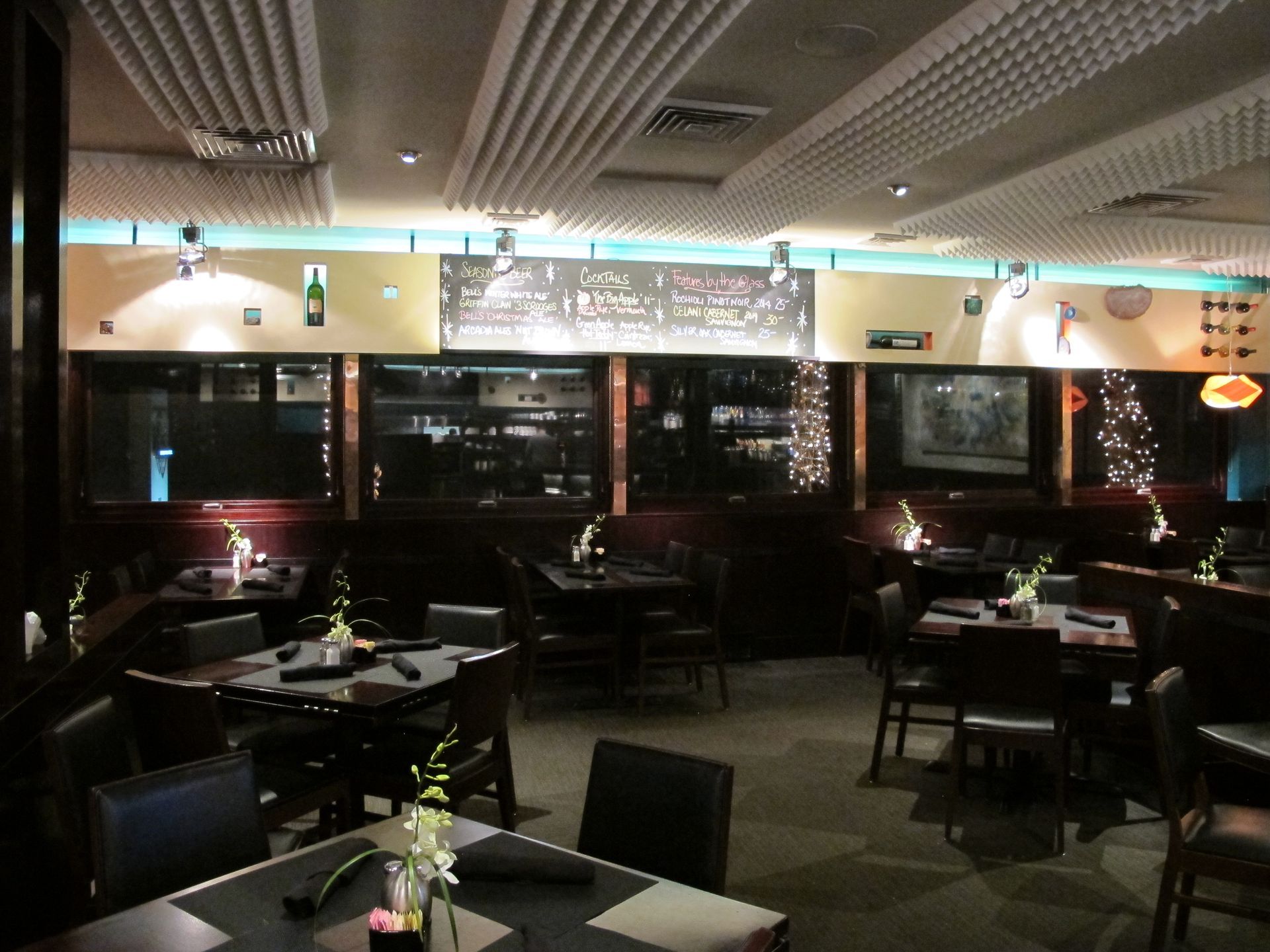 A restaurant with tables and chairs and a sign that says ' christmas ' on it