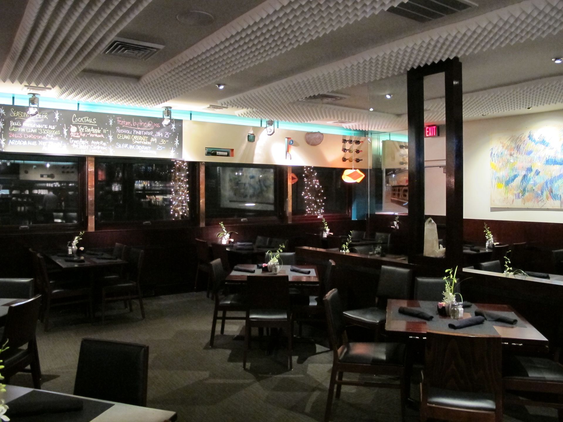 A restaurant with tables and chairs and a sign that says ' dinner ' on it