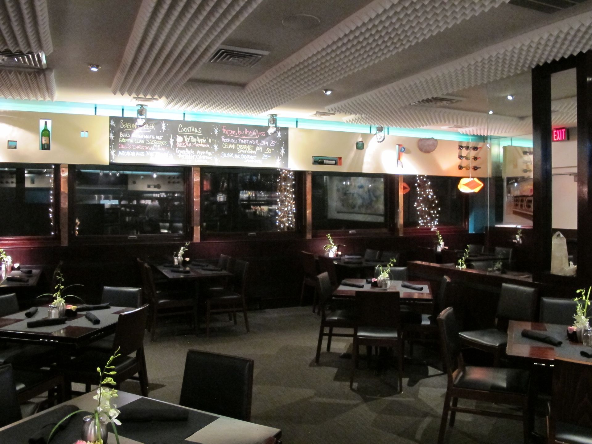 A restaurant with tables and chairs and a sign that says ' dinner ' on it