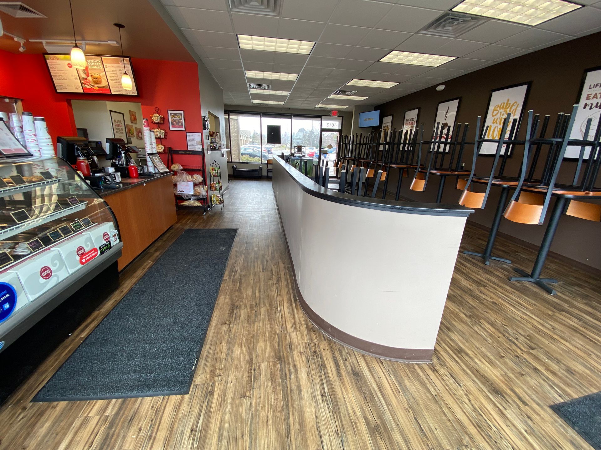 A restaurant with tables and chairs sitting on the floor.