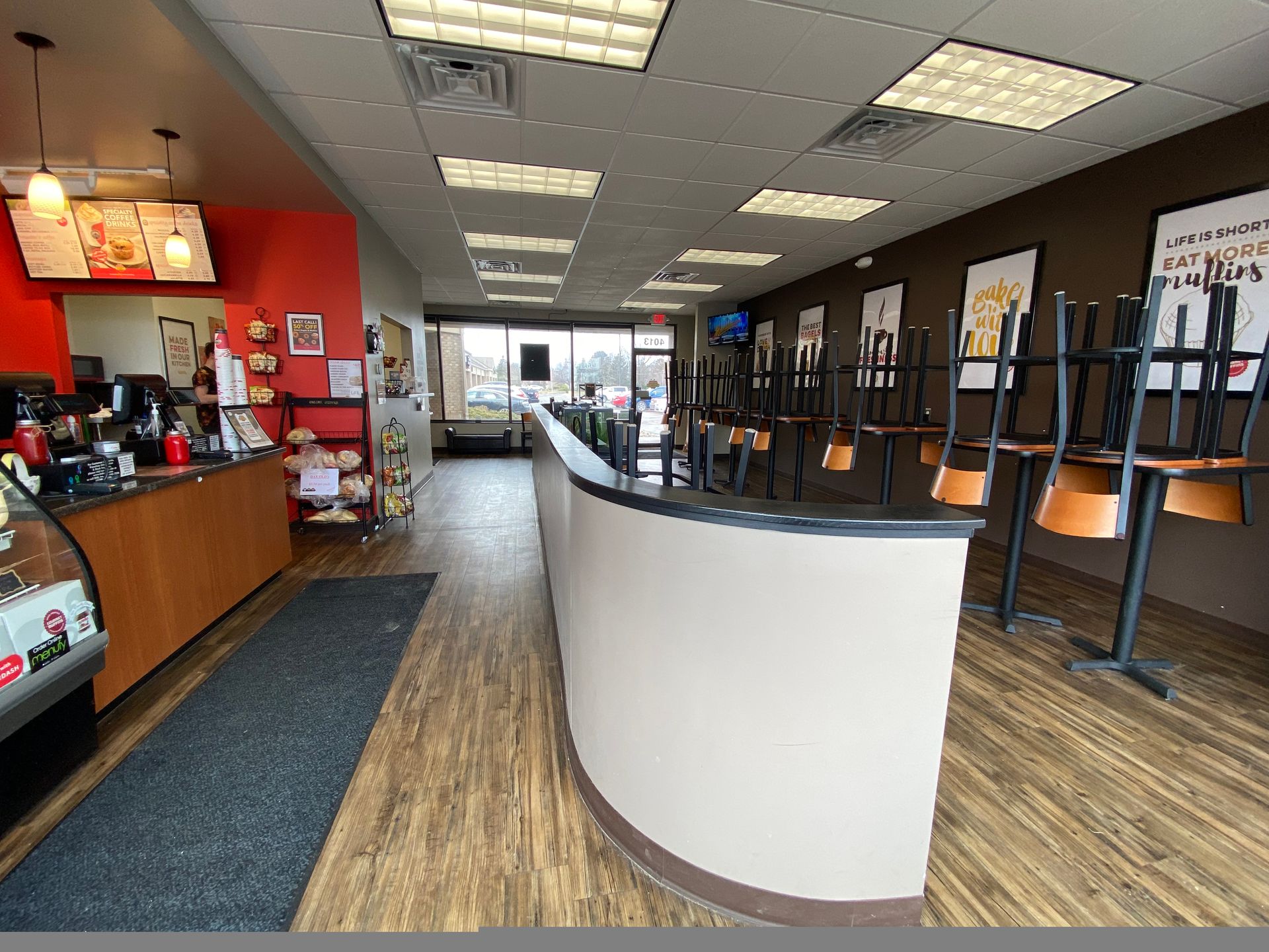 A restaurant with tables and chairs sitting on the floor.