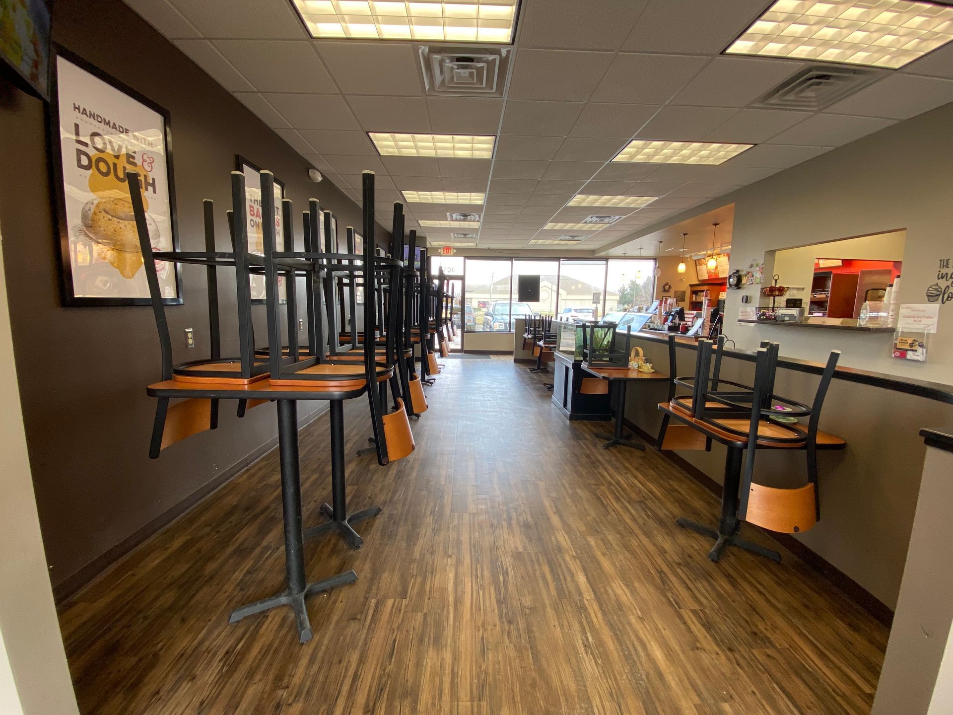 A restaurant with tables and chairs stacked on top of each other.