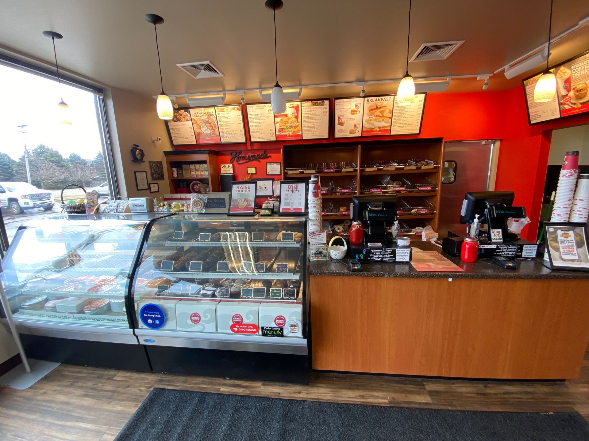 The inside of a bakery with a counter and a display case.