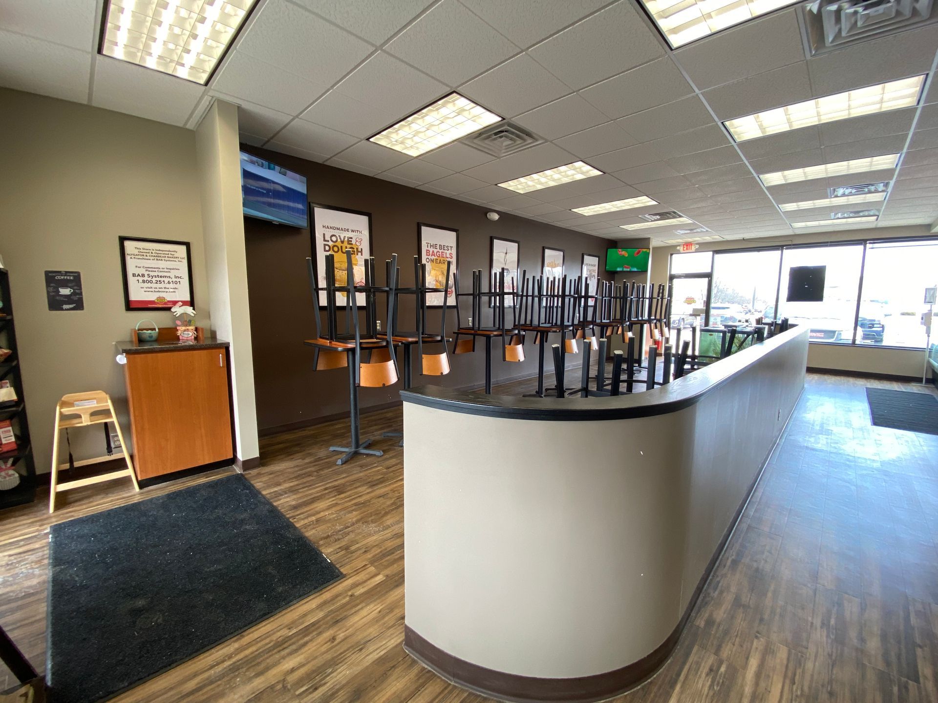 A restaurant with tables and chairs sitting on the floor.