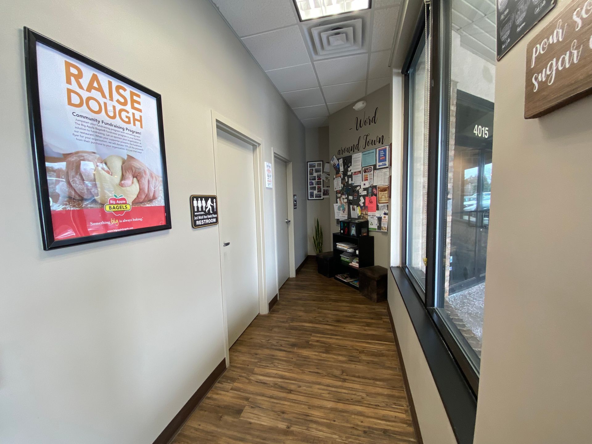 A hallway with a sign on the wall that says `` raise dough ''.