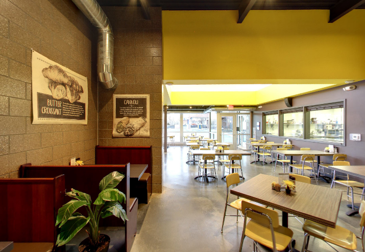 The inside of a restaurant with tables and chairs