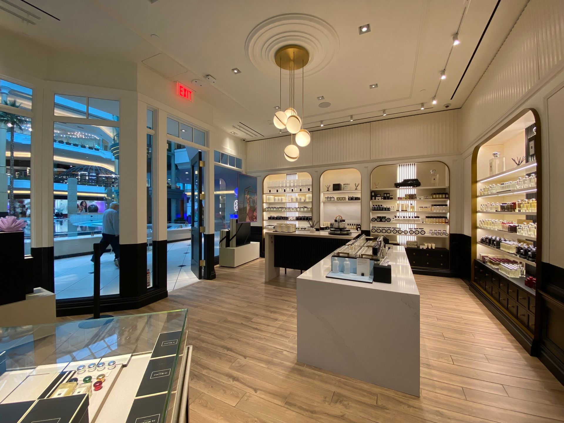 A large store with a lot of shelves and a ceiling light.