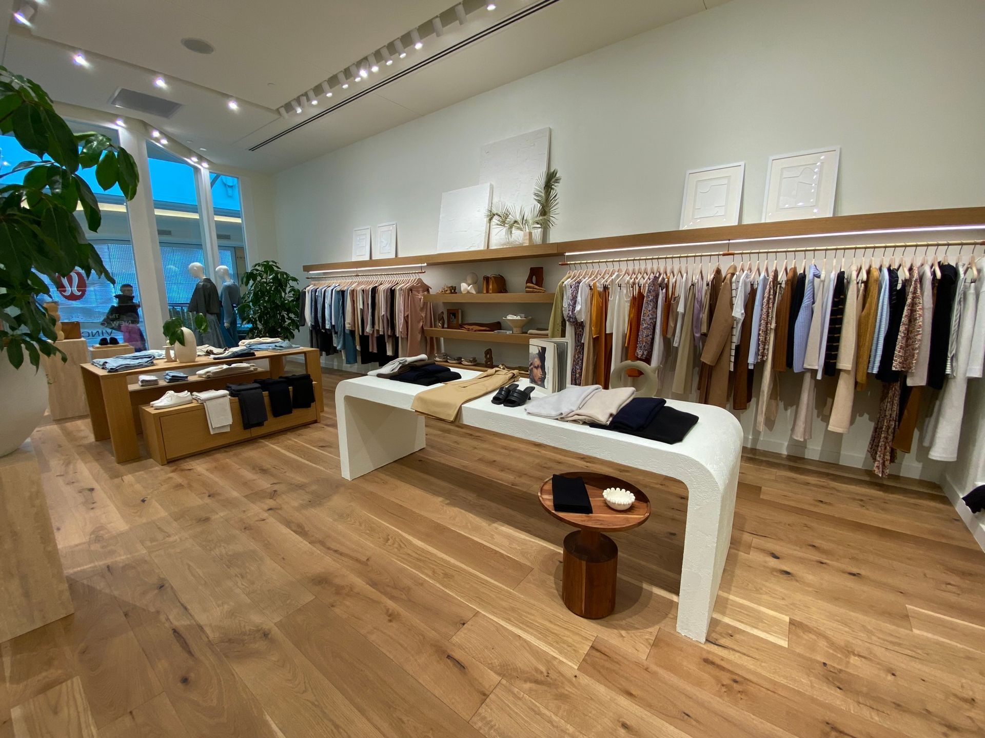 A store filled with lots of clothes and tables.